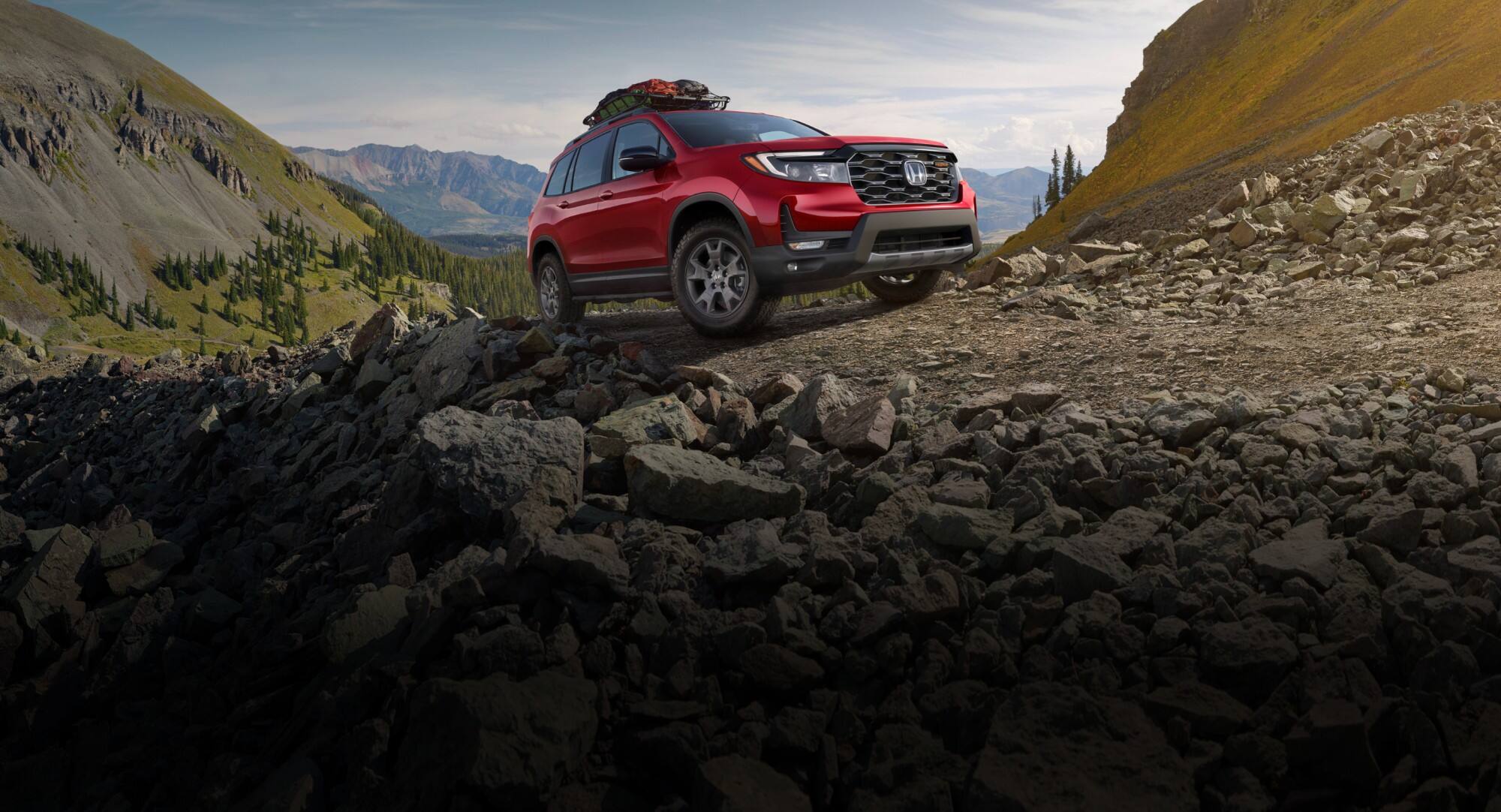 Honda Passport TrailSport in Radiant Red Metallic II parked in a mountain top